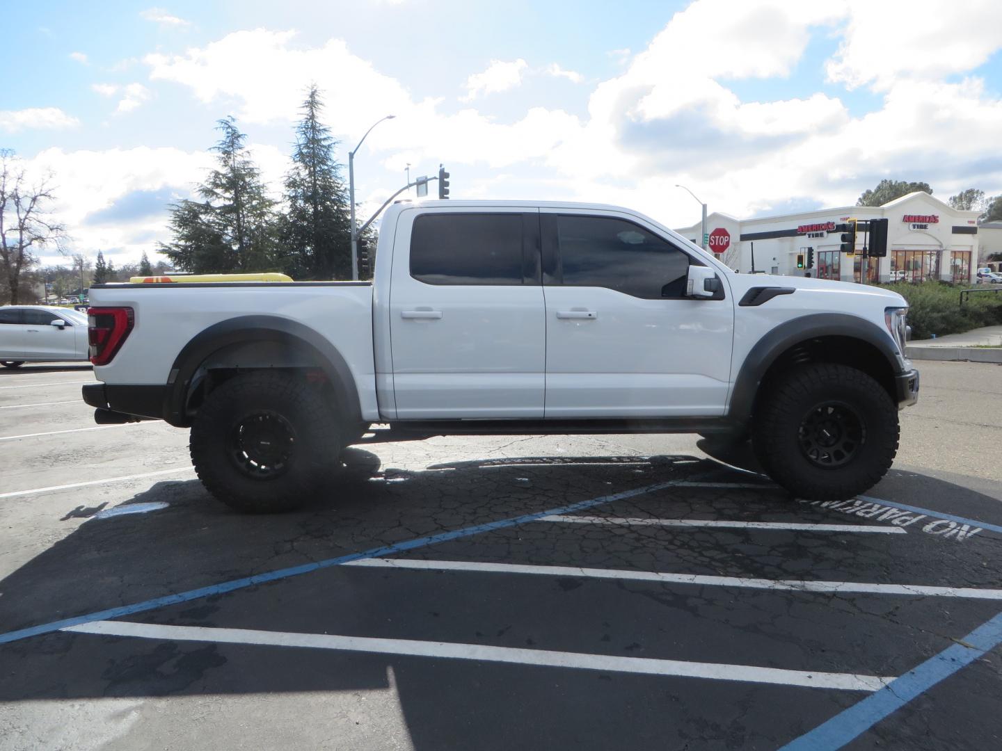 2023 White /BLACK Ford F-150 Raptor SuperCrew 4WD (1FTFW1RG6PF) with an 3.5 V6 engine, 6A transmission, located at 2630 Grass Valley Highway, Auburn, CA, 95603, (530) 508-5100, 38.937893, -121.095482 - Raptor sitting on Eibach front and rear springs, 37" Nitto Ridge Grappler tires, 17" Method NV wheels, and window tint. - Photo#3